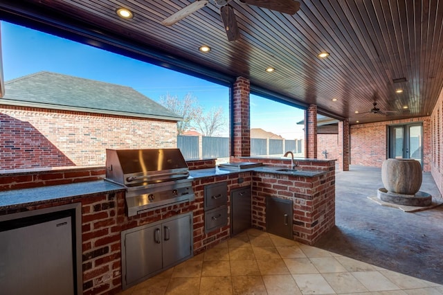 10704 Orlando Ave, Lubbock, TX 79423 - view of patio / terrace with a grill, a ceiling fan, a sink, fence, and exterior kitchen