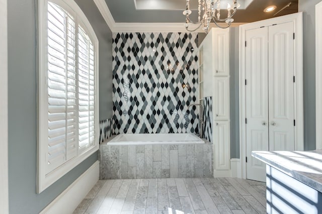 10704 Orlando Ave, Lubbock, TX 79423 - full bathroom featuring crown molding, tiled bath, wood finished floors, and a notable chandelier