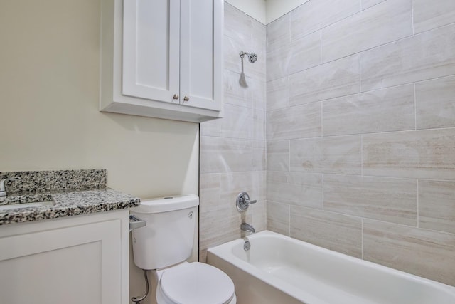 full bathroom featuring vanity, toilet, and tiled shower / bath combo