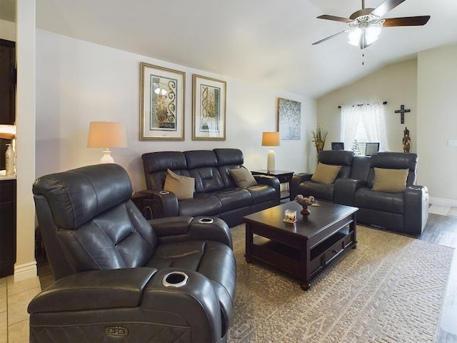 tiled living room with ceiling fan and lofted ceiling