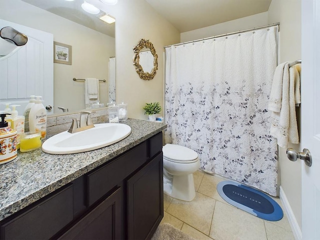 bathroom featuring tile patterned flooring, vanity, and toilet