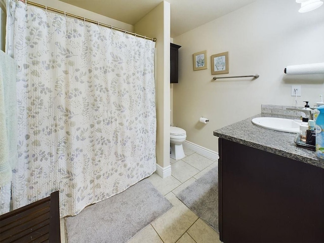 bathroom featuring vanity, tile patterned floors, and toilet