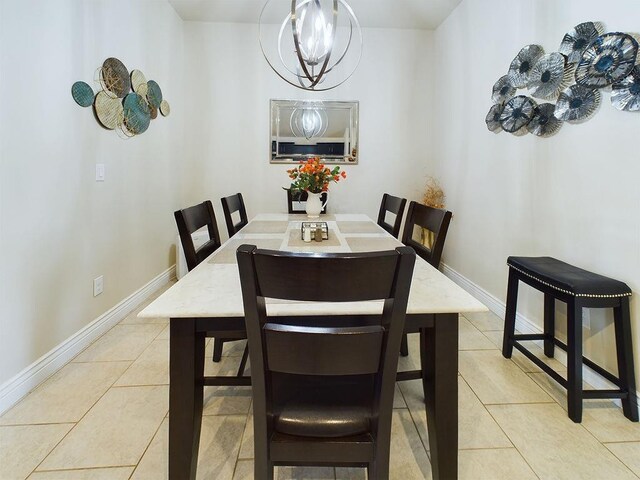 tiled dining area featuring an inviting chandelier