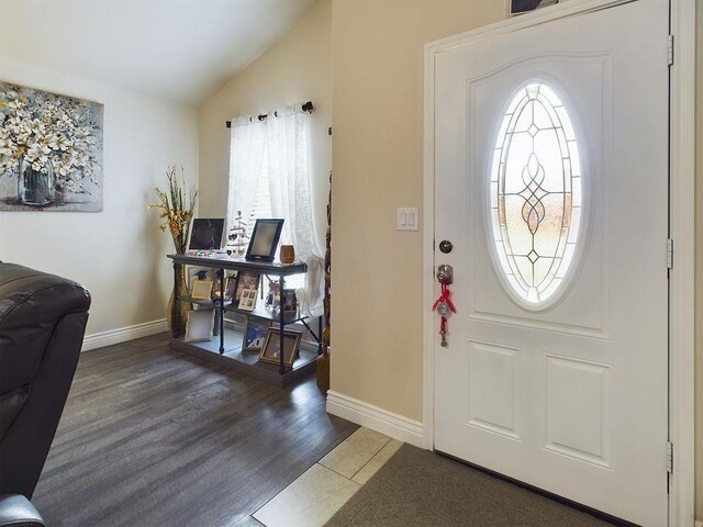 foyer entrance with vaulted ceiling and dark hardwood / wood-style floors