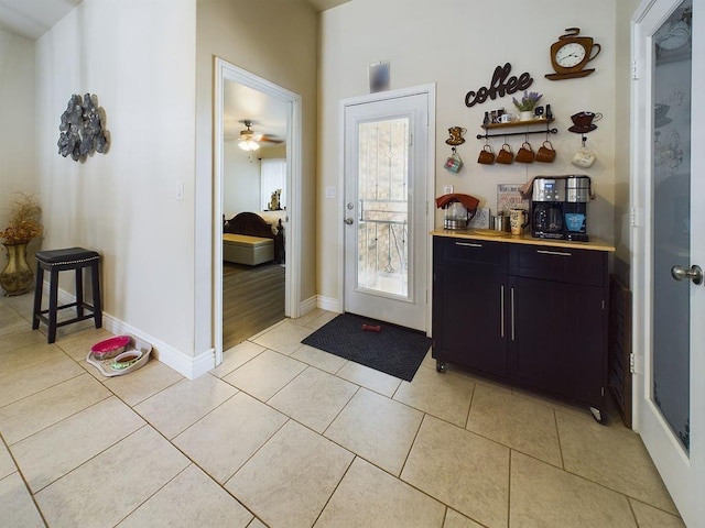 doorway with light tile patterned floors