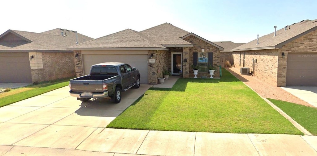 single story home featuring central AC unit, a garage, and a front yard