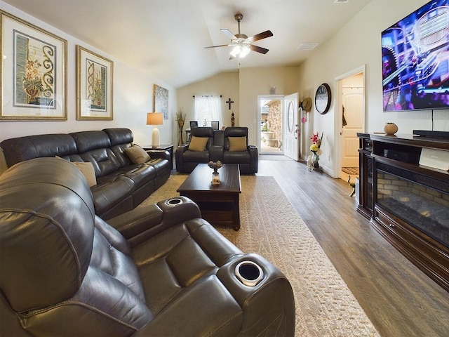 living room with lofted ceiling, dark wood-type flooring, and ceiling fan