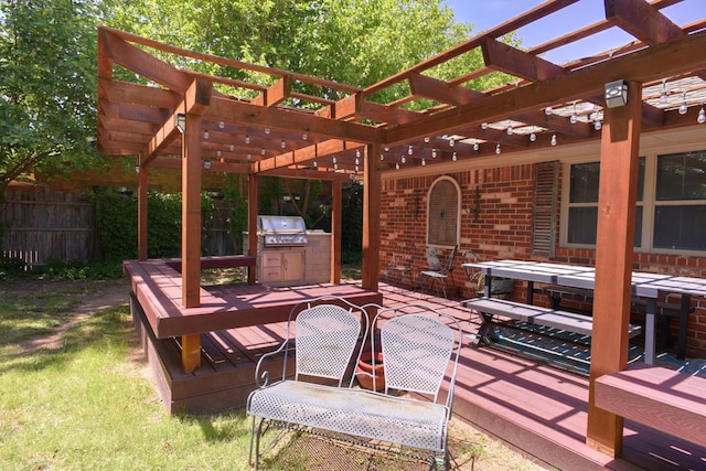 view of patio with a wooden deck, grilling area, and a pergola