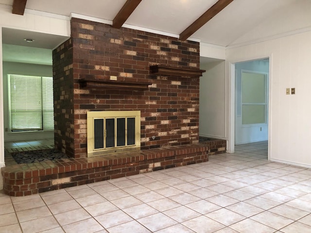 unfurnished living room featuring a brick fireplace, vaulted ceiling with beams, and light tile patterned floors