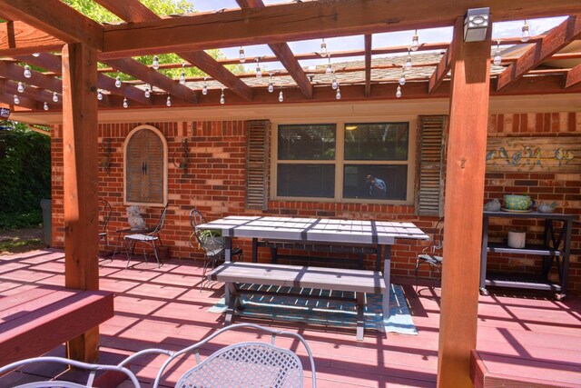 view of patio featuring a wooden deck and a pergola