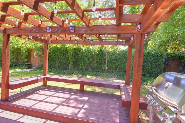 wooden terrace featuring area for grilling and a pergola