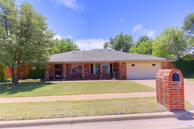 ranch-style house featuring a garage and a front yard