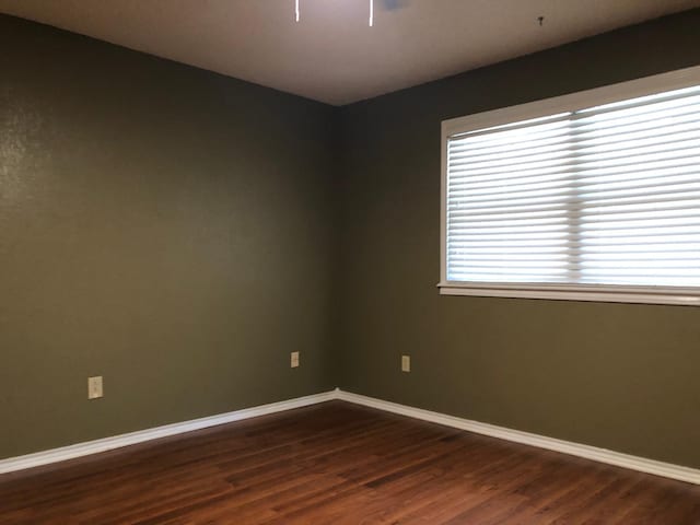 spare room with dark hardwood / wood-style floors