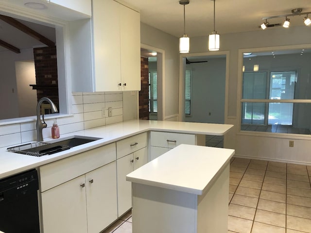 kitchen featuring dishwasher, a kitchen island, sink, and white cabinets