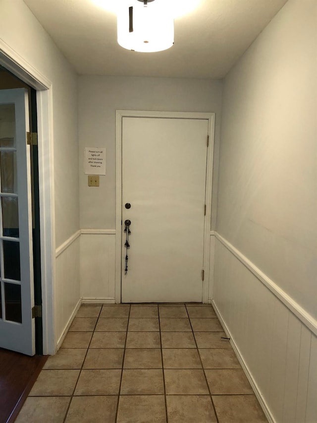 doorway featuring tile patterned flooring