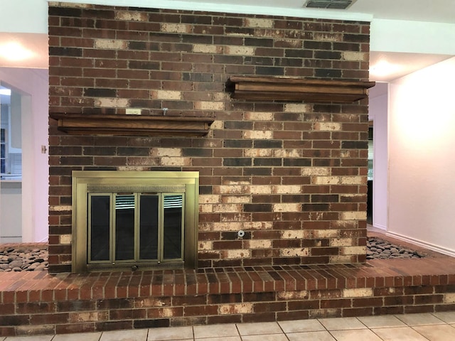 interior details featuring a brick fireplace