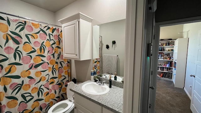 bathroom with walk in shower, vanity, and toilet