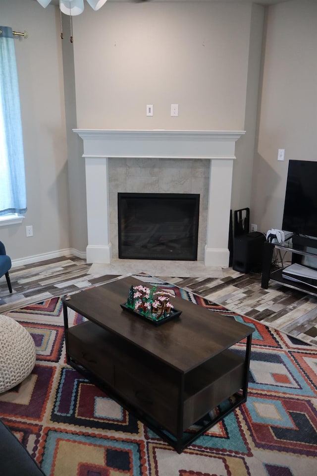 living room featuring hardwood / wood-style flooring and a tile fireplace