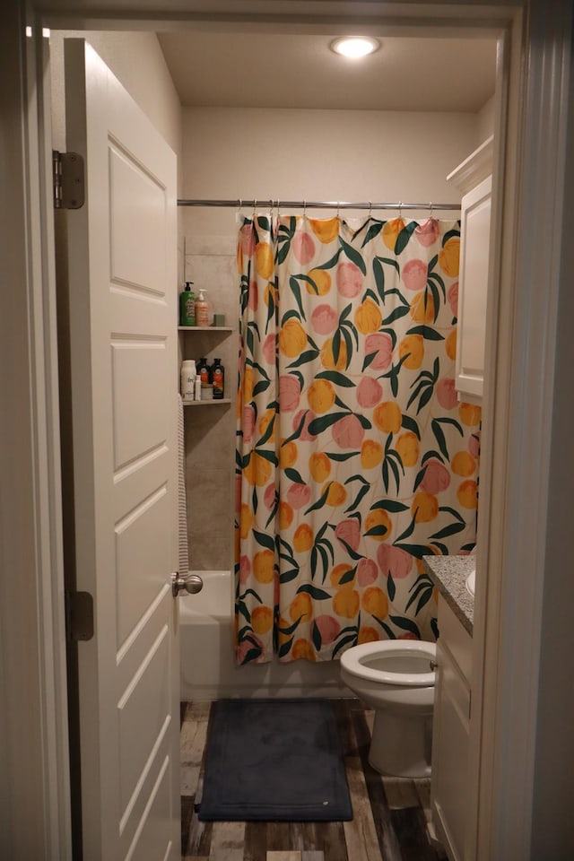 full bathroom featuring vanity, wood-type flooring, toilet, and shower / bath combo with shower curtain