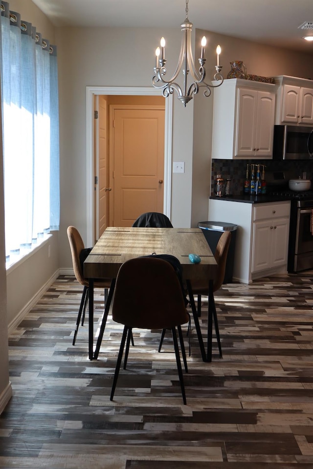 dining area featuring a notable chandelier and dark hardwood / wood-style flooring