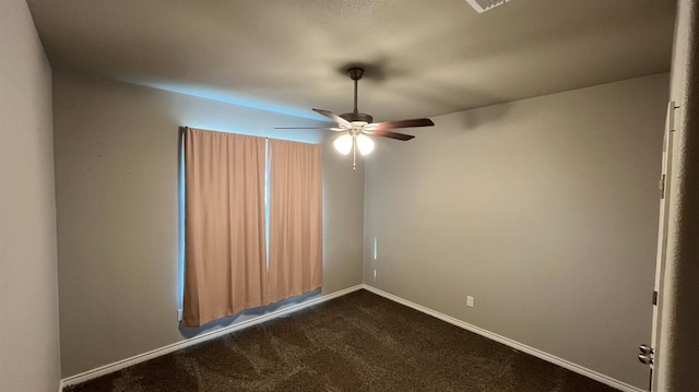 spare room featuring carpet and ceiling fan