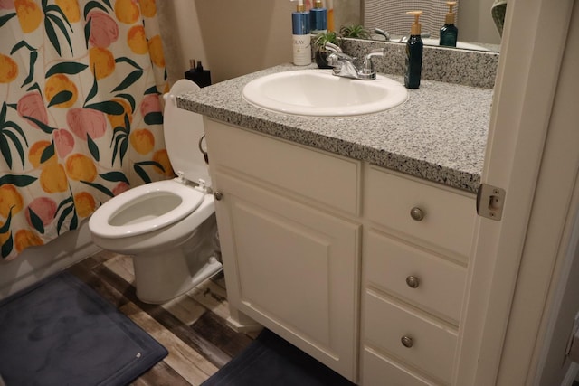 full bathroom with vanity, toilet, shower / tub combo, and wood-type flooring