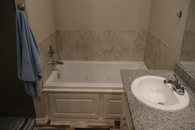 bathroom with vanity and a tub