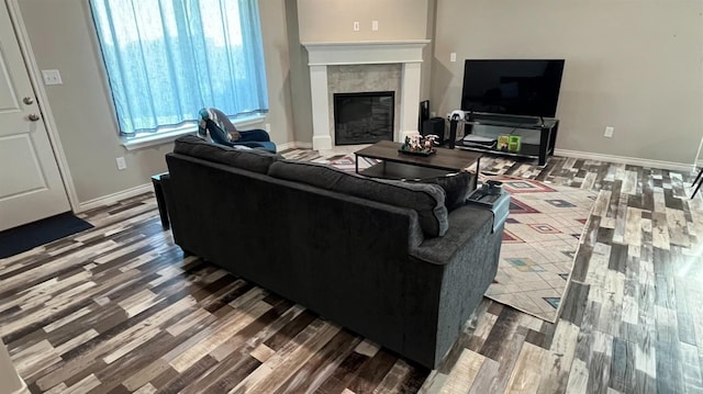 living room with hardwood / wood-style flooring and a fireplace