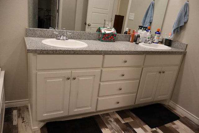 bathroom with hardwood / wood-style flooring and vanity