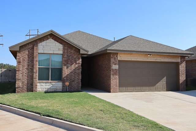 view of front of house with a garage and a front yard