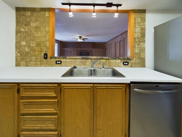 kitchen featuring dishwasher, sink, backsplash, and ceiling fan