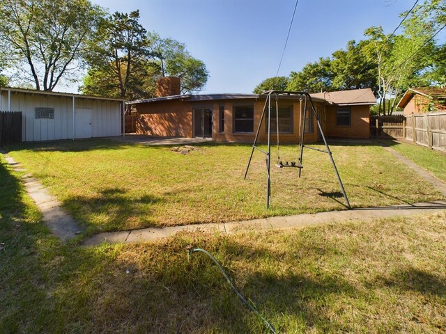 rear view of house with a lawn