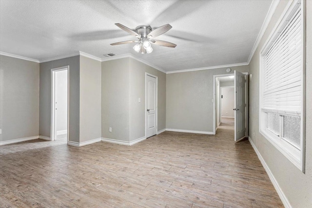 unfurnished room featuring crown molding, ceiling fan, a textured ceiling, and light hardwood / wood-style flooring