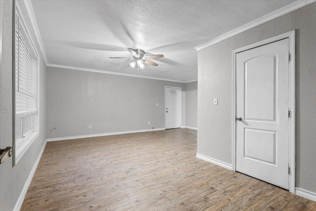 unfurnished room featuring ceiling fan, crown molding, light hardwood / wood-style floors, and a textured ceiling