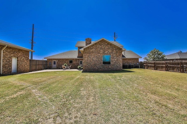 back of house featuring a yard and a patio