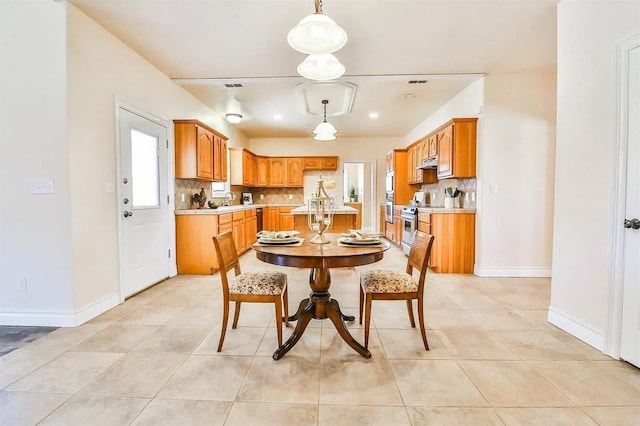 dining area with sink and light tile patterned floors