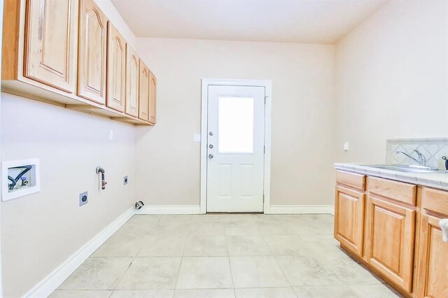 washroom with gas dryer hookup, sink, cabinets, hookup for a washing machine, and hookup for an electric dryer