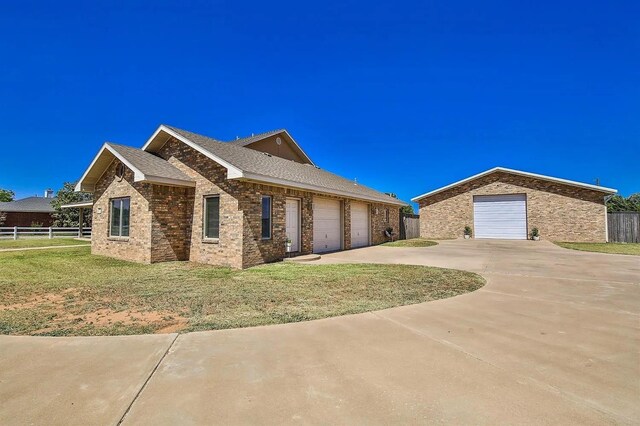 ranch-style house with a garage and a front lawn