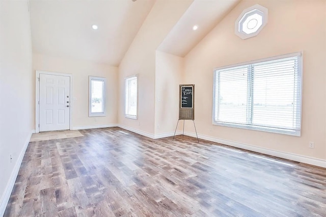 interior space featuring hardwood / wood-style flooring and high vaulted ceiling