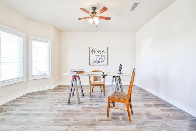 office space featuring ceiling fan and light wood-type flooring