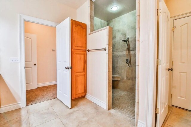 bathroom with tile patterned floors and a tile shower