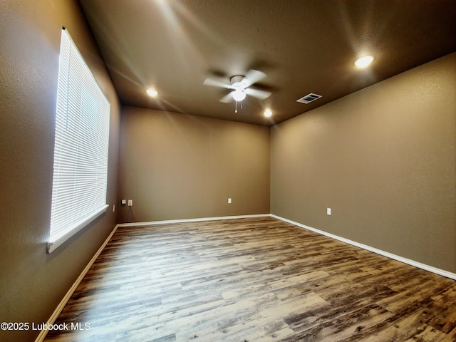 2834 E 7th St, Lubbock, TX 79403 - empty room with ceiling fan, wood finished floors, baseboards, and recessed lighting