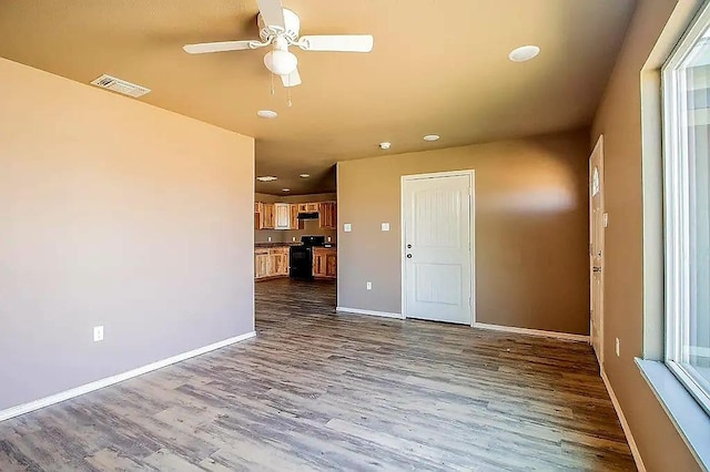 empty room with hardwood / wood-style flooring and ceiling fan