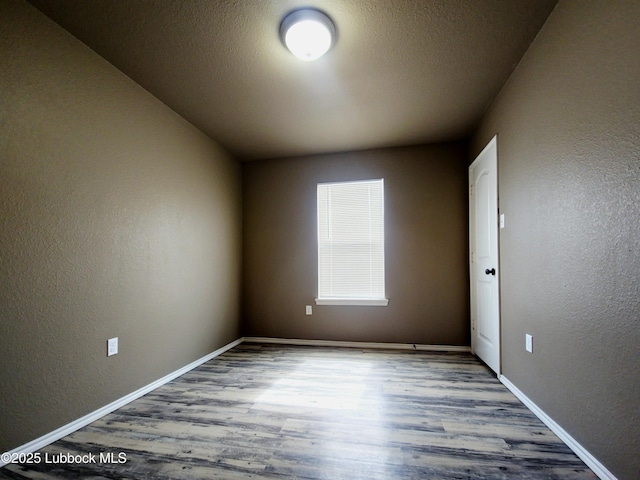 2834 E 7th St, Lubbock, TX 79403 - unfurnished room with a textured wall, wood finished floors, and baseboards