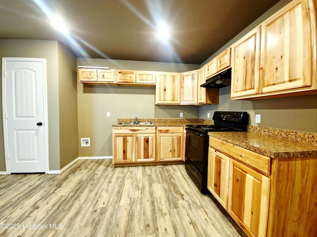 2834 E 7th St, Lubbock, TX 79403 - kitchen featuring black / electric stove, under cabinet range hood, a sink, light wood finished floors, and baseboards