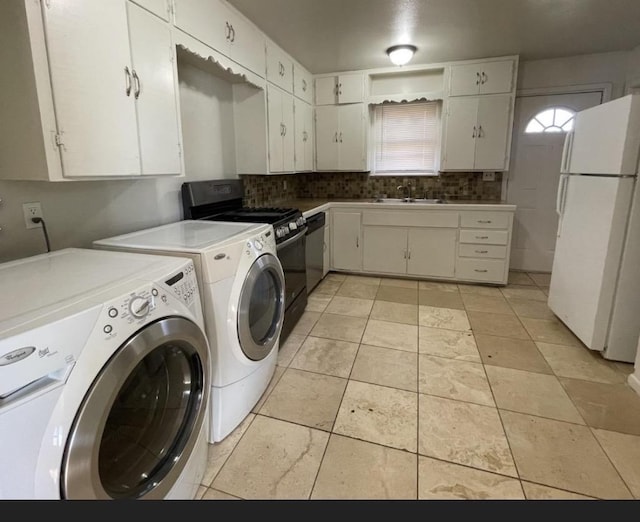 laundry area with separate washer and dryer, sink, and light tile patterned floors