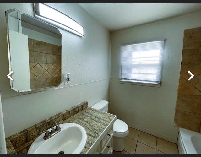 bathroom featuring vanity, toilet, and tile patterned flooring