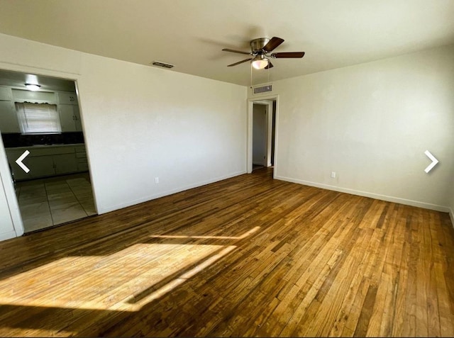 unfurnished room with hardwood / wood-style floors and ceiling fan