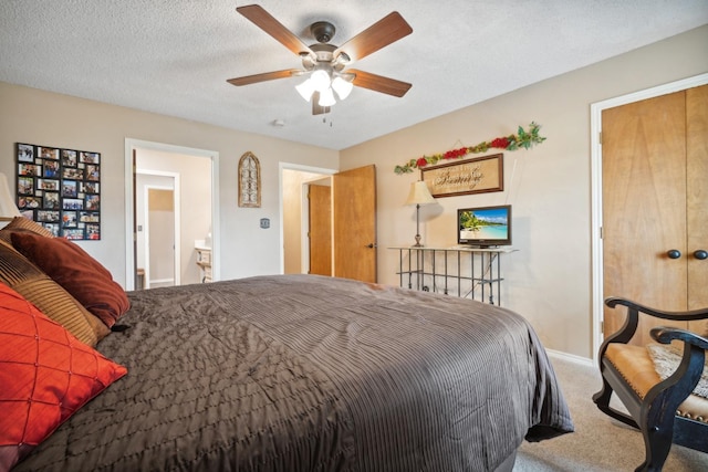 carpeted bedroom with ceiling fan and a textured ceiling