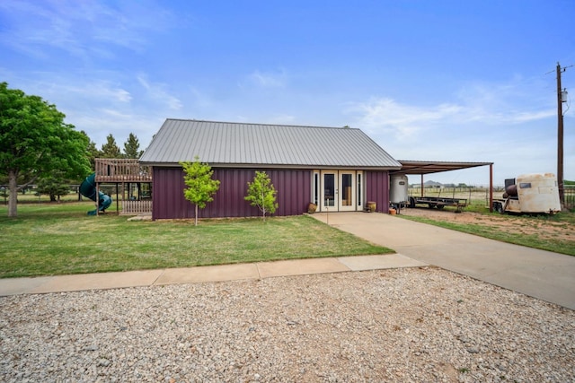 view of front of home with a front lawn and french doors